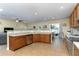 Spacious kitchen with stainless appliances, tile backsplash, and an adjacent dining area at 420 Tulipwood Ln, Chuluota, FL 32766