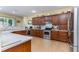 Spacious kitchen featuring wooden cabinetry, tiled backsplash, stainless steel appliances, and abundant countertop space at 420 Tulipwood Ln, Chuluota, FL 32766