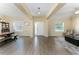 Spacious living and dining area with wood-look tile flooring, a dining table, and natural light at 420 Tulipwood Ln, Chuluota, FL 32766