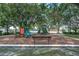 Community playground with slides and play structures under mature trees offers outdoor fun at 420 Tulipwood Ln, Chuluota, FL 32766