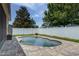 Private in-ground pool area with brick paver patio and white vinyl privacy fence at 420 Tulipwood Ln, Chuluota, FL 32766