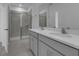 Contemporary bathroom featuring a double sink vanity, a glass-enclosed shower, and neutral tiled flooring at 502 Belmond Dr, Debary, FL 32713