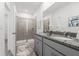 Modern bathroom featuring double sinks, granite countertops, and a walk-in shower at 502 Belmond Dr, Debary, FL 32713