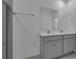 Modern bathroom with double vanity, sleek gray cabinets, large mirror, and a glass-enclosed shower at 502 Belmond Dr, Debary, FL 32713