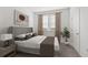 Inviting bedroom featuring a comfortable bed, neutral decor, and natural light from the window at 502 Belmond Dr, Debary, FL 32713