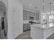 Contemporary kitchen featuring gray cabinetry, stainless steel appliances, a center island and white countertops at 502 Belmond Dr, Debary, FL 32713