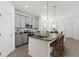 Modern kitchen with gray cabinets, granite countertops, stainless steel appliances and island seating at 502 Belmond Dr, Debary, FL 32713
