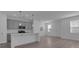 Modern kitchen and living room area with stainless steel appliances and recessed lighting at 502 Belmond Dr, Debary, FL 32713