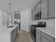 Kitchen featuring gray cabinets, stainless steel appliances, white countertops, and light wood-look flooring at 502 Belmond Dr, Debary, FL 32713