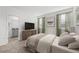Serene main bedroom with neutral tones, large windows, and a view of the en-suite bathroom at 502 Belmond Dr, Debary, FL 32713