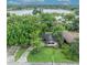 Aerial view of a home with a lush, green yard, mature trees and lake views showcase the property's serene setting at 504 W Faith Ter, Maitland, FL 32751