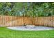 Fenced backyard with a stone fire pit and lush landscaping at 504 W Faith Ter, Maitland, FL 32751
