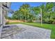 Spacious backyard patio featuring stone pavers, a lush lawn, and mature trees at 504 W Faith Ter, Maitland, FL 32751