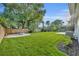 Expansive backyard with lush lawn, mature trees, a firepit, and privacy fence create a tranquil outdoor space at 504 W Faith Ter, Maitland, FL 32751