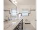 Bright bathroom showcases marble countertop, black vanity, white tile, and hexagon tile flooring at 504 W Faith Ter, Maitland, FL 32751