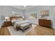 Serene bedroom featuring a comfortable bed, dresser, bench, and soft natural lighting at 504 W Faith Ter, Maitland, FL 32751