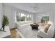 Bright living room with large windows, white sofa, accent chairs, and contemporary decor at 504 W Faith Ter, Maitland, FL 32751