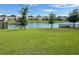 Beautiful backyard overlooking a large pond with lush green grass at 5054 Tibet Ct, St Cloud, FL 34772