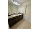 Double vanity bathroom featuring granite countertops and dark cabinets at 5054 Tibet Ct, St Cloud, FL 34772