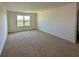 Large bedroom featuring plush carpet and a large window at 5054 Tibet Ct, St Cloud, FL 34772