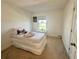 Bedroom showcasing neutral walls and carpet, with a twin bed and a window with a pleasant view at 5054 Tibet Ct, St Cloud, FL 34772