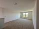 Spacious bonus room featuring plush carpet and a bright window at 5054 Tibet Ct, St Cloud, FL 34772