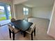 View of the dining area with a table set for four, with a view of the backyard at 5054 Tibet Ct, St Cloud, FL 34772