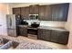 Contemporary kitchen featuring stainless steel appliances and granite countertops at 5054 Tibet Ct, St Cloud, FL 34772