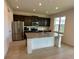 Well-equipped kitchen featuring stainless steel appliances, granite countertops and dark wood cabinets at 5054 Tibet Ct, St Cloud, FL 34772