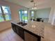 Open kitchen features a large granite island and stainless steel sink at 5054 Tibet Ct, St Cloud, FL 34772