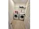 Laundry room featuring a washer and dryer with tile flooring, offering convenience and functionality for chores at 5054 Tibet Ct, St Cloud, FL 34772