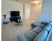 Stylish living room features a modern couch, TV, and neutral tile floors at 5054 Tibet Ct, St Cloud, FL 34772