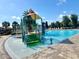 Community pool featuring a splash pad, water features, and ample lounge chairs at 5054 Tibet Ct, St Cloud, FL 34772