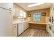 Well-lit kitchen featuring classic white cabinetry, appliances, and an adjacent functional desk area at 508 W Plantation Blvd, Lake Mary, FL 32746