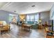 Bright living room with large windows, comfortable seating, laminate flooring, and tasteful decor at 508 W Plantation Blvd, Lake Mary, FL 32746