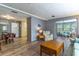 Inviting living room featuring an open layout with laminate flooring, leading to sunroom and dining area at 508 W Plantation Blvd, Lake Mary, FL 32746