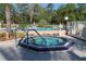 Resort-style community pool and hot tub surrounded by lush landscaping and a white fence at 508 W Plantation Blvd, Lake Mary, FL 32746