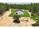 Aerial view of a modern home, featuring a well-manicured lawn and a private driveway at 6106 Sw 127 Avenue Rd, Ocala, FL 34481