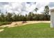 Expansive grassy backyard with a treeline in the distance offers plenty of space at 6106 Sw 127 Avenue Rd, Ocala, FL 34481