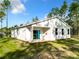 Rear view of modern home with white stucco, and a covered patio leading to spacious yard at 6106 Sw 127 Avenue Rd, Ocala, FL 34481