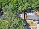 A bird's eye view of the house shows lush landscaping and tree coverage at 626 Pearl Rd, Winter Springs, FL 32708