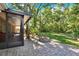 Backyard featuring a stone paver patio, an enclosed porch, and a stone firepit at 626 Pearl Rd, Winter Springs, FL 32708