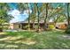 A view of the rear of the home featuring a spacious yard and covered back porch at 626 Pearl Rd, Winter Springs, FL 32708