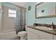 Charming bathroom with tiled shower, granite countertop, and a built-in vanity at 626 Pearl Rd, Winter Springs, FL 32708