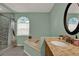 Bright bathroom with tile floors and granite countertop, soaking tub and tiled shower at 626 Pearl Rd, Winter Springs, FL 32708