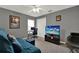 Bedroom with a comfortable sofa and workstation, providing a versatile space for relaxation and work at 626 Pearl Rd, Winter Springs, FL 32708