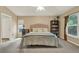 Cozy bedroom with neutral tones, carpet flooring, and a comfortable bed with a decorative headboard at 626 Pearl Rd, Winter Springs, FL 32708