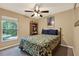 Bedroom featuring a floral patterned comforter, ceiling fan, and a window providing natural light at 626 Pearl Rd, Winter Springs, FL 32708
