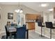 Dining area adjacent to open kitchen with bar stool seating at 626 Pearl Rd, Winter Springs, FL 32708