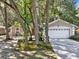 Exterior home featuring a two car garage and landscaped yard at 626 Pearl Rd, Winter Springs, FL 32708